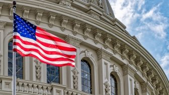 Washington DC Capitol dome detail with waving american flag