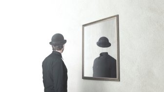 identity absence surreal concept; man in front of mirror reflecting himself without face