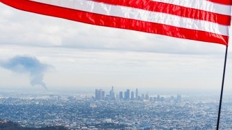 Flag over American city with pollution