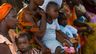  Portrait of a young mother and her baby daughter during a community meeting, at the Bissaque neighborhood in the city of Bissau, Guinea Bissau.