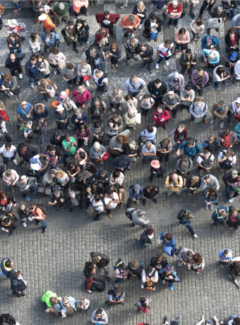 Large group of tourists gathering in a crowded Old Town Square