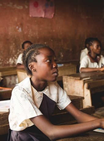 children sitting on chairs inside classroom