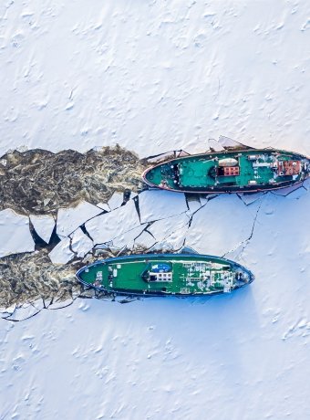 Two icebreakers breaking ice on Vistula river, Poland, 2020-02-18, aerial view