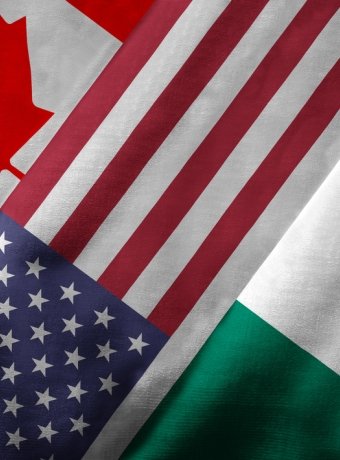 Close up of the flags of the North American Free Trade Agreement NAFTA members on textile texture. NAFTA is the world's largest trade bloc and member countries are Canada, United States and Mexico.