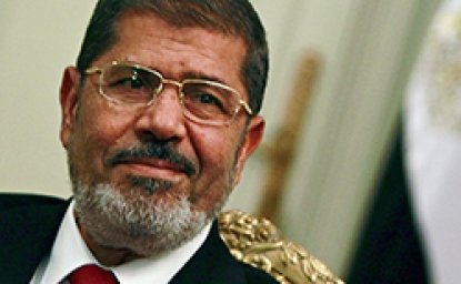 Egypt's first Islamist president Mohamed Mursi attends during his meeting with Turkish Foreign Minister Ahmet Davutoglu at the presidential palace in Cairo July 2, 2012. Egypt will approach the International Monetary Fund (IMF) and other financial institutions to help get its economy back on track once Mursi appoints a government, one of his financial advisers told Reuters. 