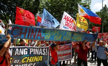 Demonstrators display a part of a fishing boat with anti-China protest signs during a rally by different activist groups over the South China Sea disputes, outside the Chinese Consulate in Makati City, Metro Manila, Philippines 