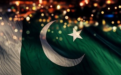 A Pakistani flag on a background of lights