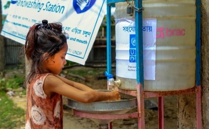 Child in a Cox’s Bazar refugee camp washes their hands in a newly installed wash station as a precaution for Covid-19