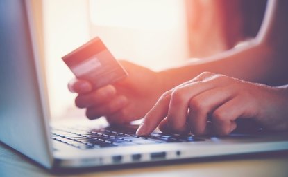 Person making a credit card purchase with computer