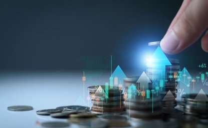 Image of a hand setting a coin on top of a pile of other coins