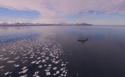 Photo of a ship sailing near ice