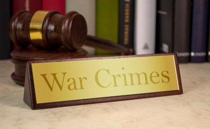 image of plaque reading "War Crimes" with gavel