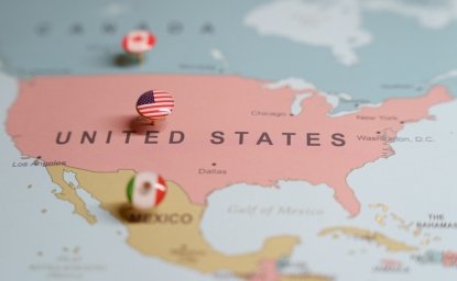  US flag push pin marking the United States on a map, with Mexico and Canada location pins visible. High quality photo