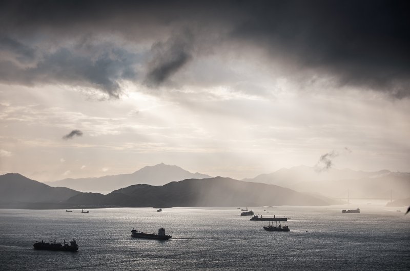 Container ships in the ocean at sunset.