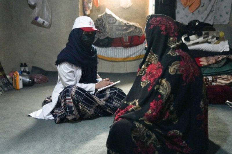 Afghan Red Crescent Mobile Health Team staff member providing essential health services to Afghan women.