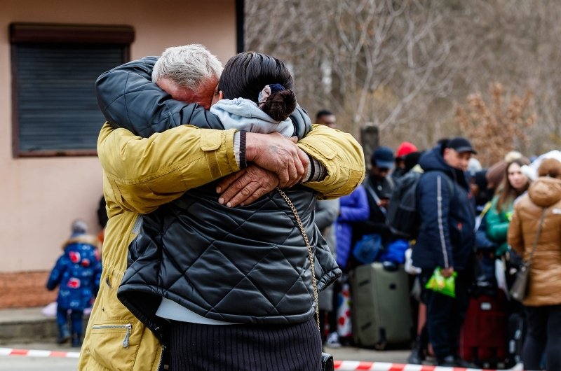 Ukrainian refugees embrace