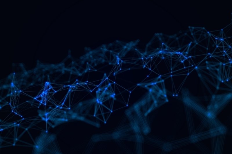 A dark background with a glowing blue network of interconnected nodes and lines