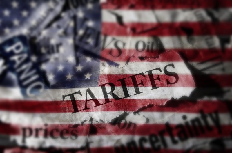 Tariffs news headlines over an American flag