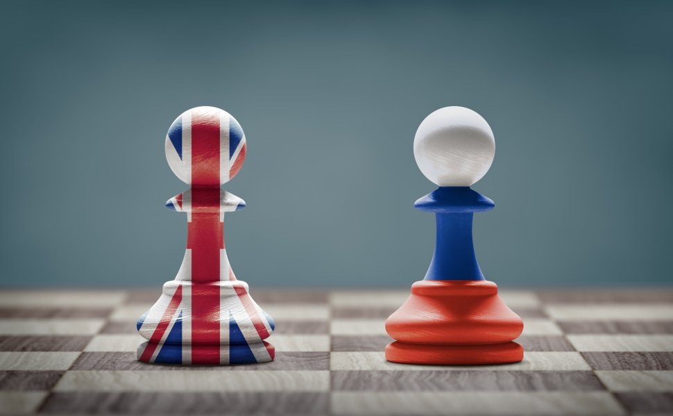 UK and Russia conflict. Country flags on chess pawns on a chess board. 3D illustration.