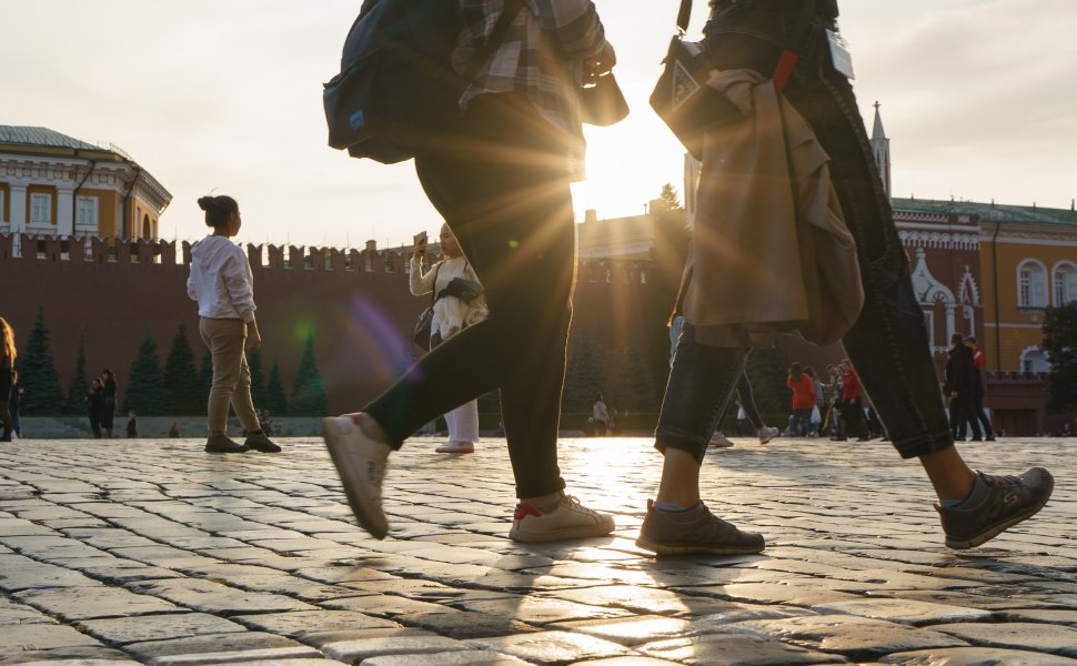 Two women walk across Red Square in Moscow