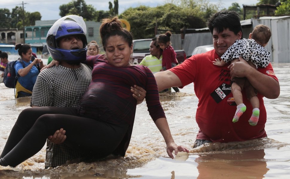 A pregnant woman is carried out of an area flooded by water brought by Hurricane Eta in Planeta, Honduras, Nov. 5, 2020.