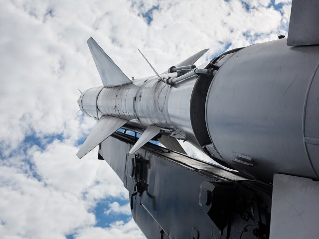 A military rocket pointed into a cloudy sky