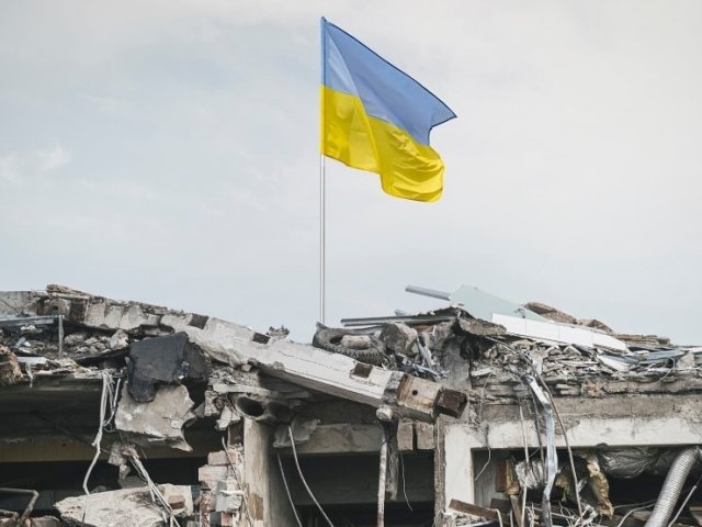 Ukraine flag over wreckage