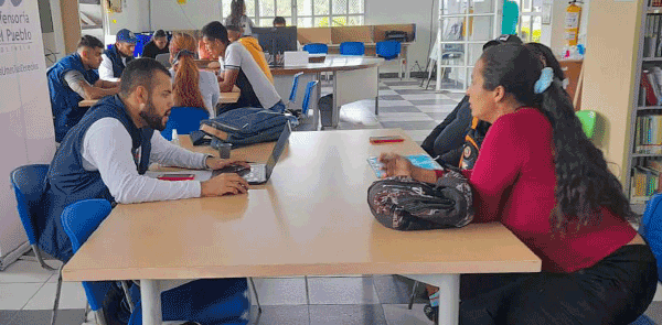 People sitting at table in library