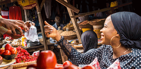 Selling tomatoes in local African market