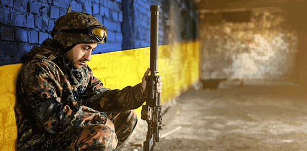 Soldier in front of Ukraine Flag