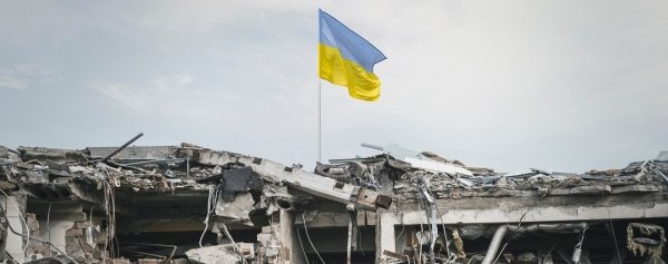 Ukraine flag over wreckage