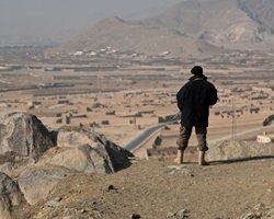 Afghan Security Guard Overlooking a Town