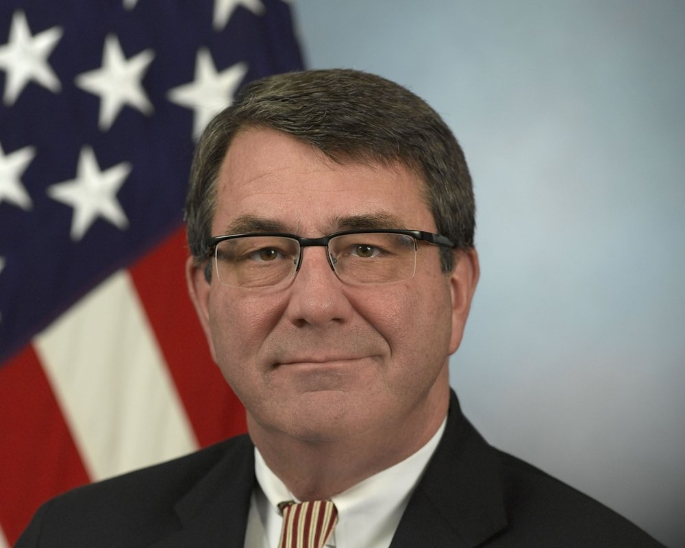 Secretary of Defense Ash Carter steadies his hand using the