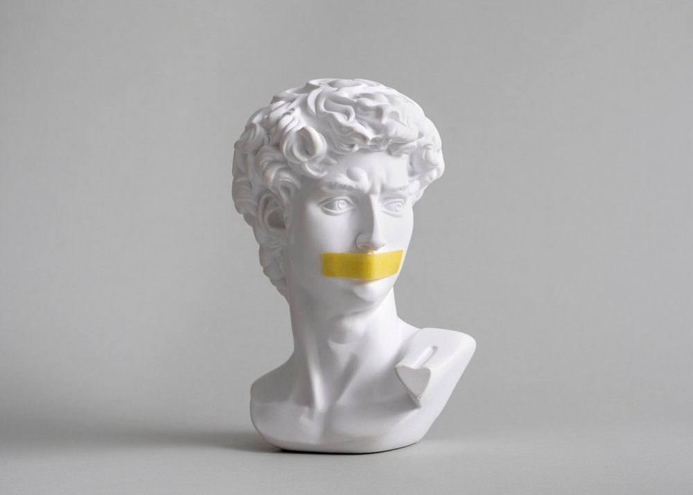 Michelangelo's David head bust with duct tape sealed mouth. 