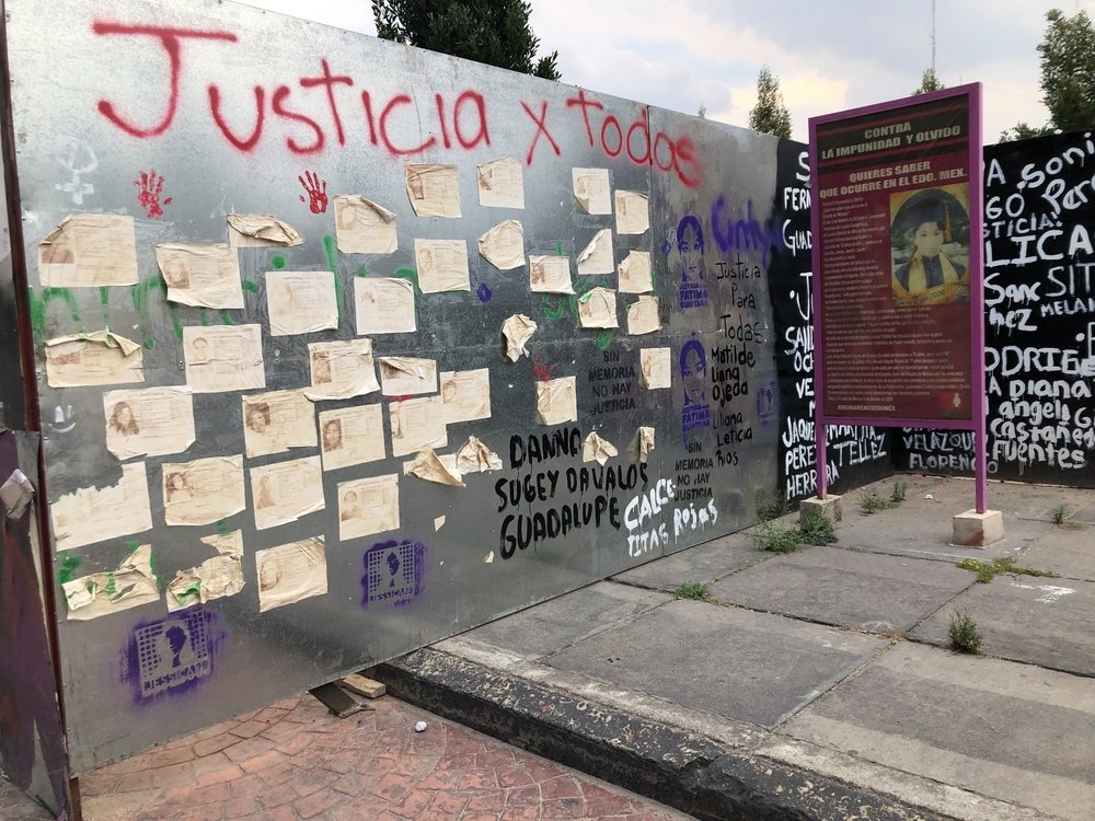 Wall full of messages claiming justice for all the women victims of violence
