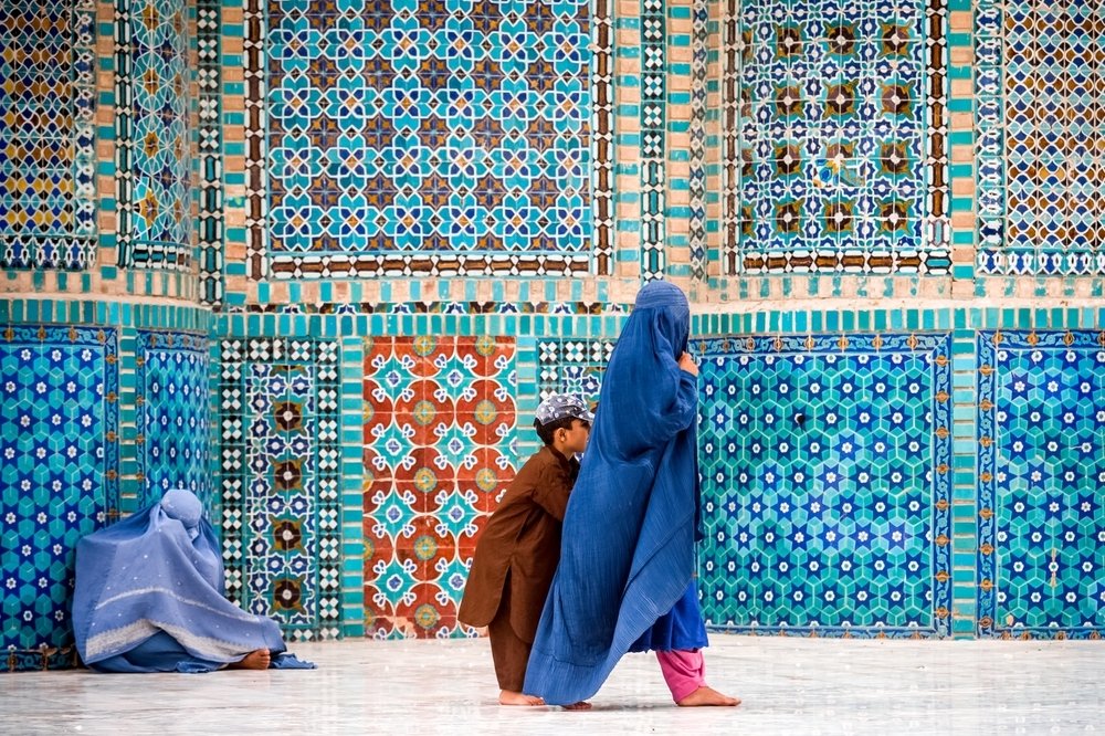 Afghan Women Walking in Front of Tiles