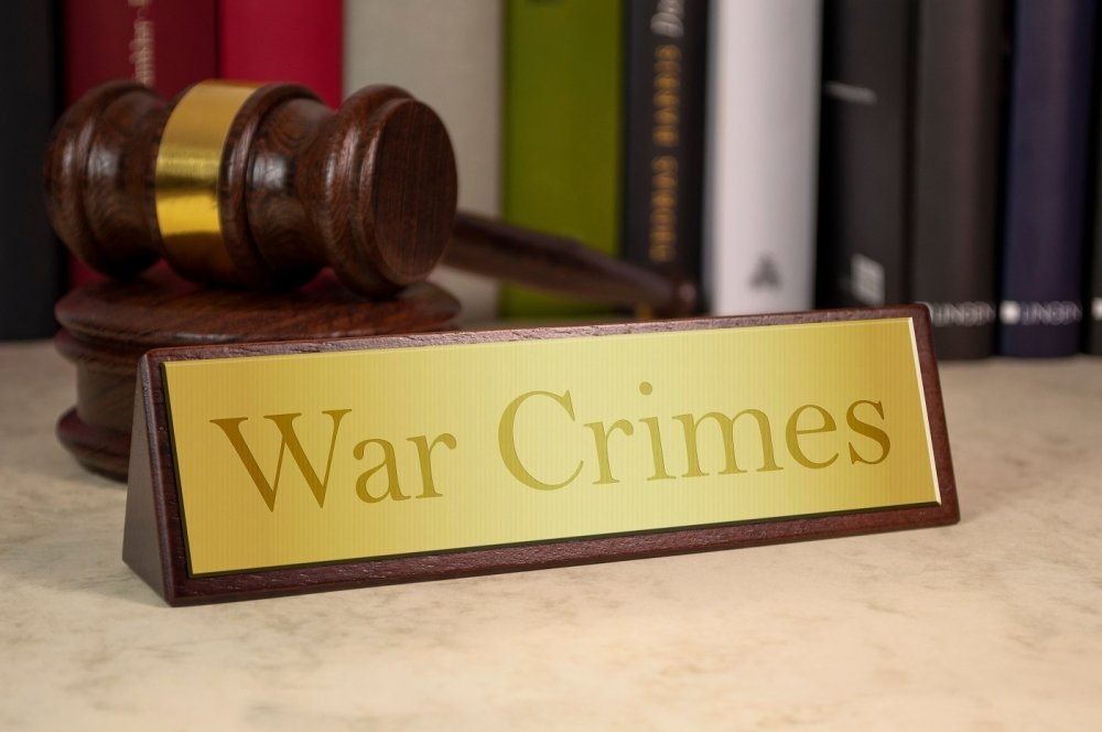 image of plaque reading "War Crimes" with gavel