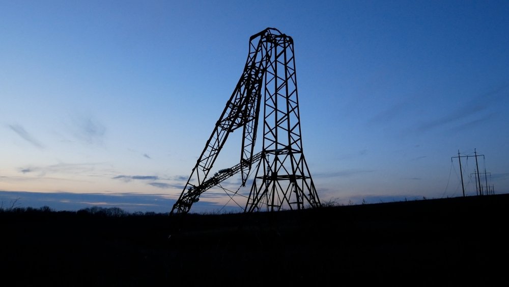 A high-voltage power tower broken as a result of a Russian missile strike against the sky. 