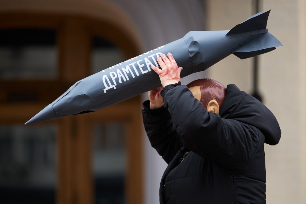 Actor in mask of vladimir putin attacks civilians with the rocket during the art performance dedicated to the anniversary of russian airstrike on Mariupol Drama Theatre in 2022.