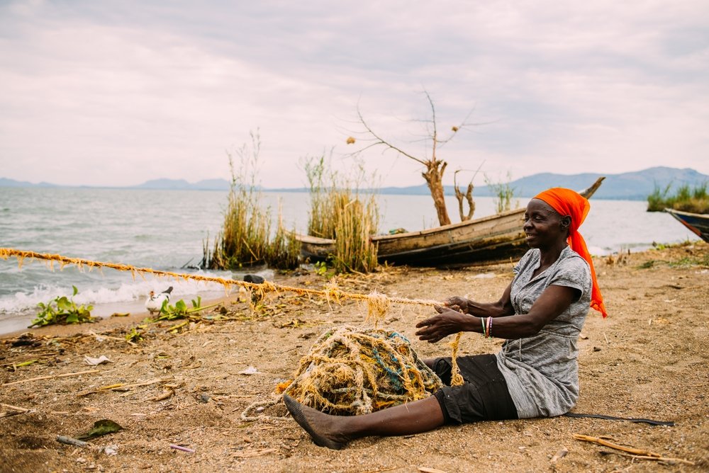 A woman fishing near Lake Victoria