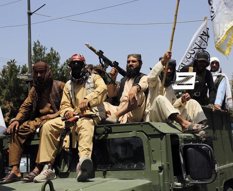 Taliban fighters celebrate the third anniversary of the withdrawal of US-led troops from Afghanistan, in Kabul, Afghanistan, Wednesday, Aug. 14, 2024. (AP Photo/Siddiqullah Alizai)