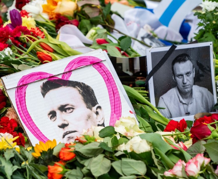 Pictures of Alexei Navalny are seen among flowers at his memorial in Berlin.