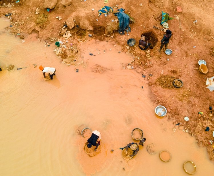 Kunsu, Ghana, March 20, 2023: Rural Women in Small Scale Mining (Galamsey) in Ghana, Africa. The quest for the daily meal of these women relies on them finding gold in an already mined land.