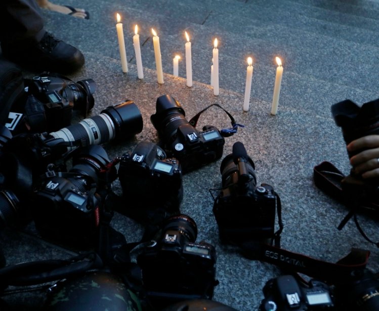 Cameras at a candlelight vigil