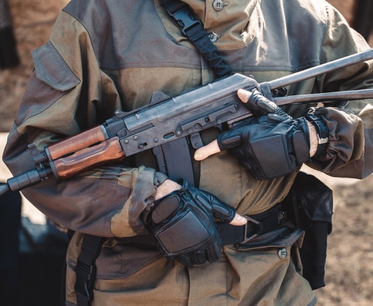 Man in Military Uniform Holding Weapon