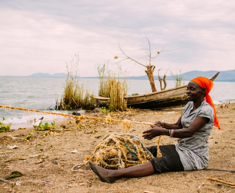 A woman fishing near Lake Victoria