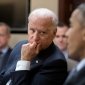 A picture of Joe Biden listening to President Obama speaking.