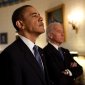 President Obama and Joe Biden stand next to each other in the Oval Office.