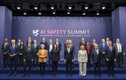 A group of world leaders positioned in front of a AI Safety Summit sign in November 2023.