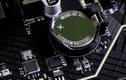 A battery on an electronics motherboard that says Lithium Ion, Made in China